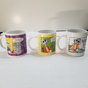 Maxine mugs (3 total), one white, one yellow, and one purple